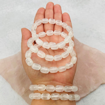 Selenite Gemstone Crystal Stretch Bracelets - Oval Beads in hand for size reference 