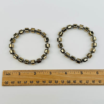 pyrite bracelets next to a ruler for size reference 