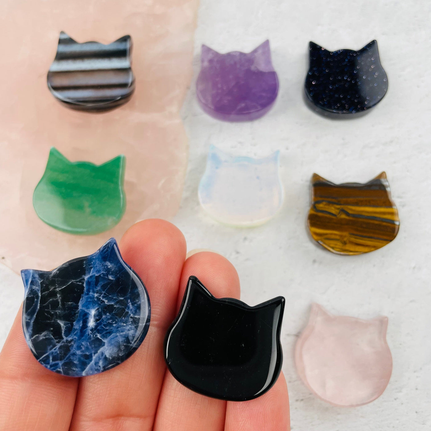 Cat Cabochons in hand for size reference 