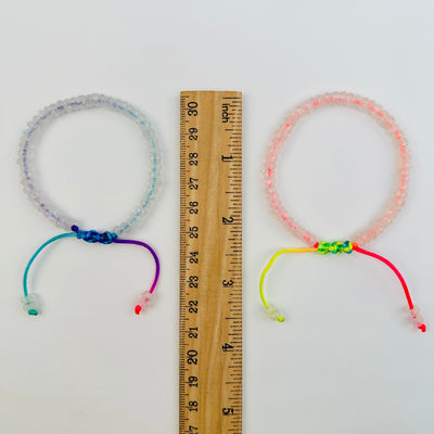 bracelets next to a ruler for size reference 