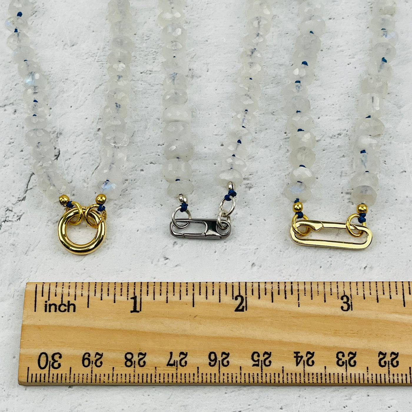 clasps next to a ruler for size reference 