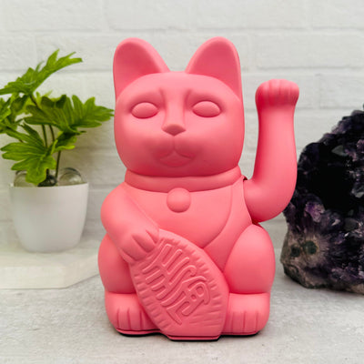 pink lucky cat displayed as home decor 