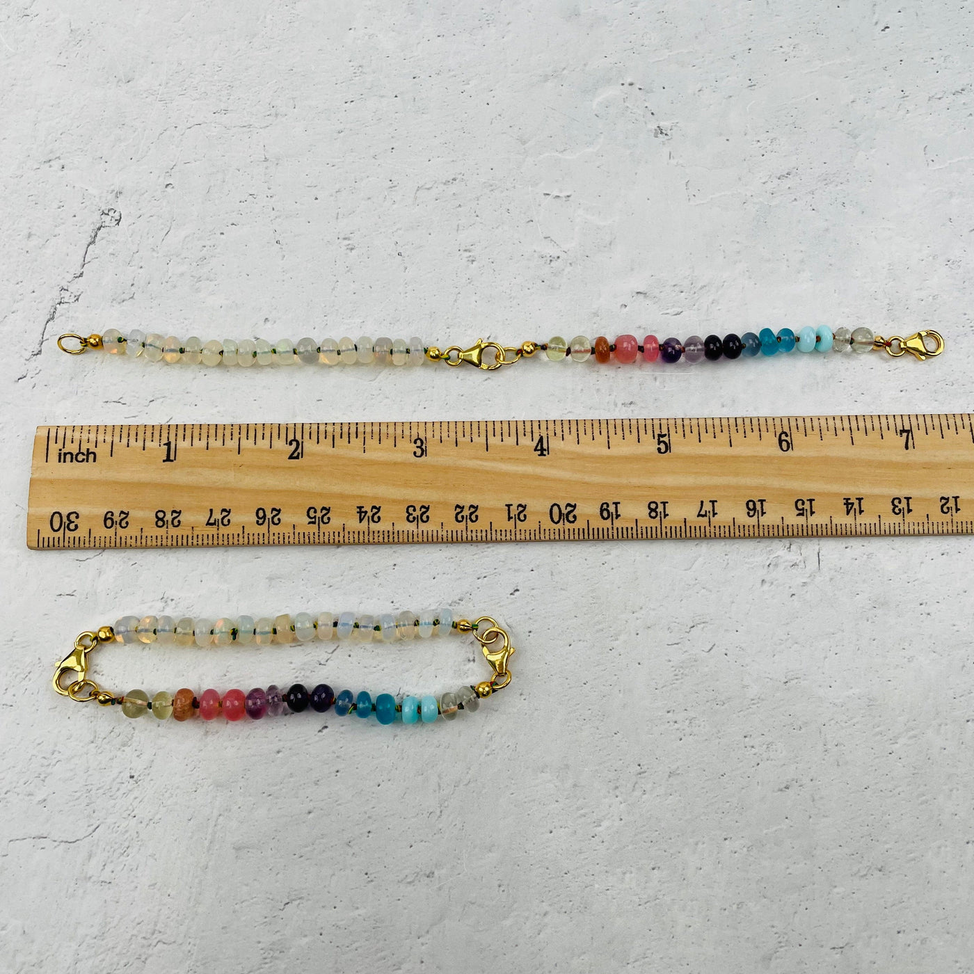 Bracelet and Necklace Extender next to a ruler for size reference 