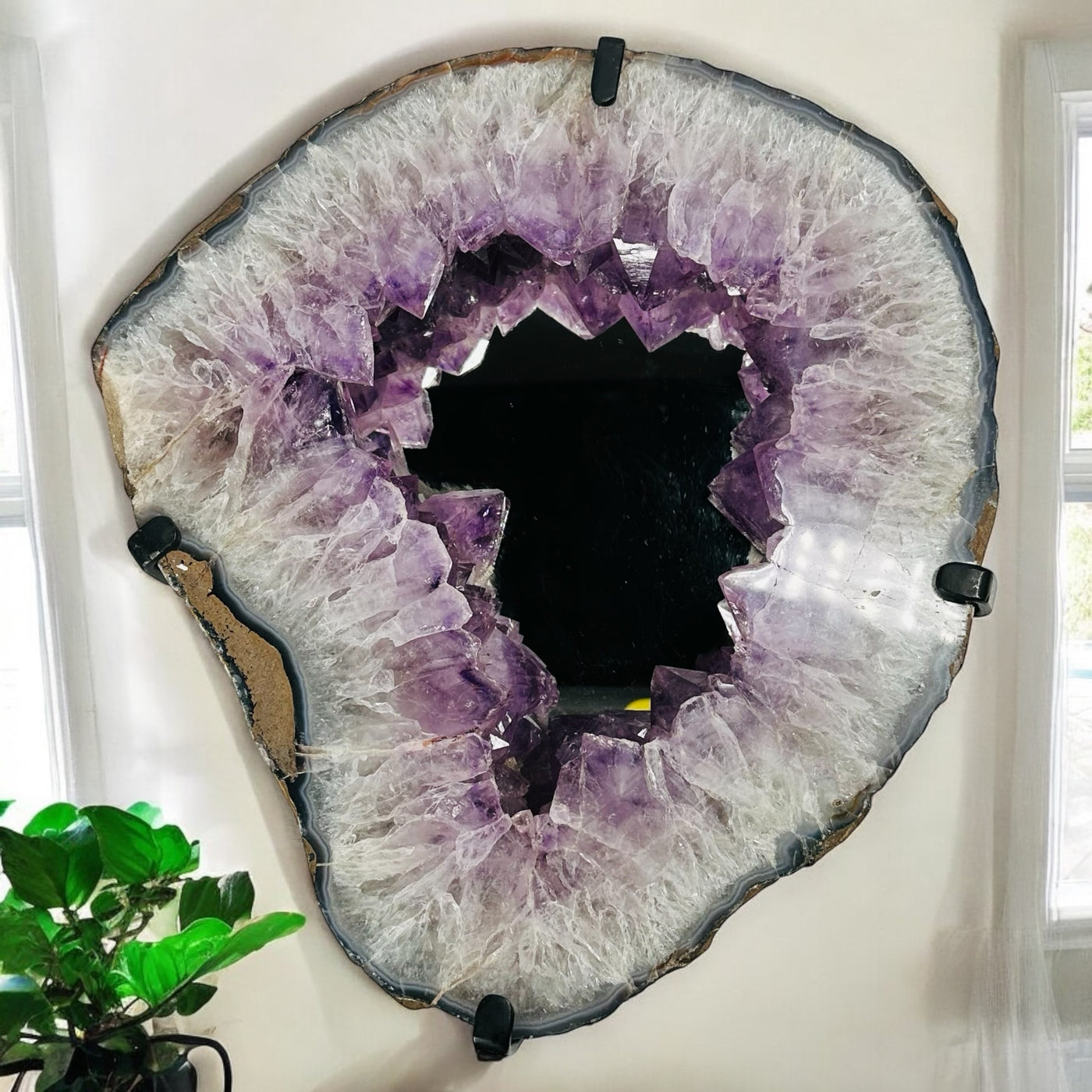 Amethyst crystal cluster mirror displayed as home decor 