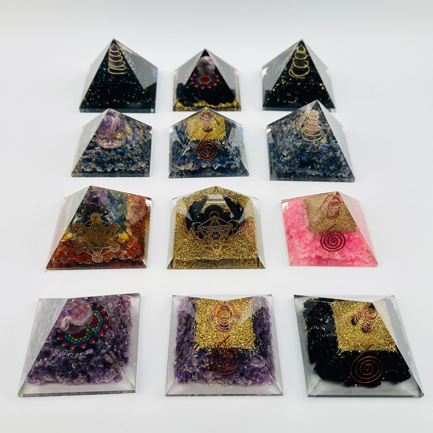 orgone pyramids displayed to show the differences in the crystal types and styles 