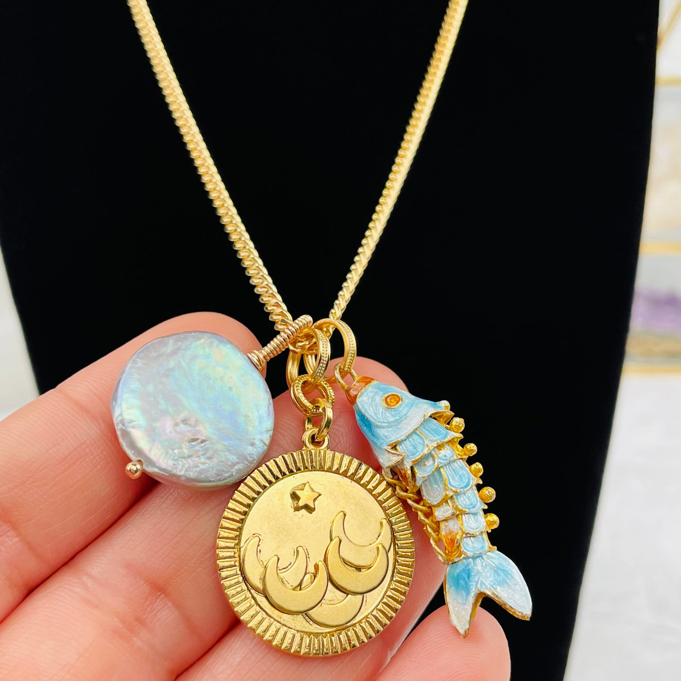 close up of the details on the star and moon medallion necklace 
