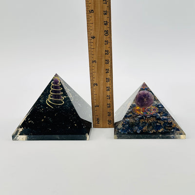 pyramids next to a ruler for size reference 