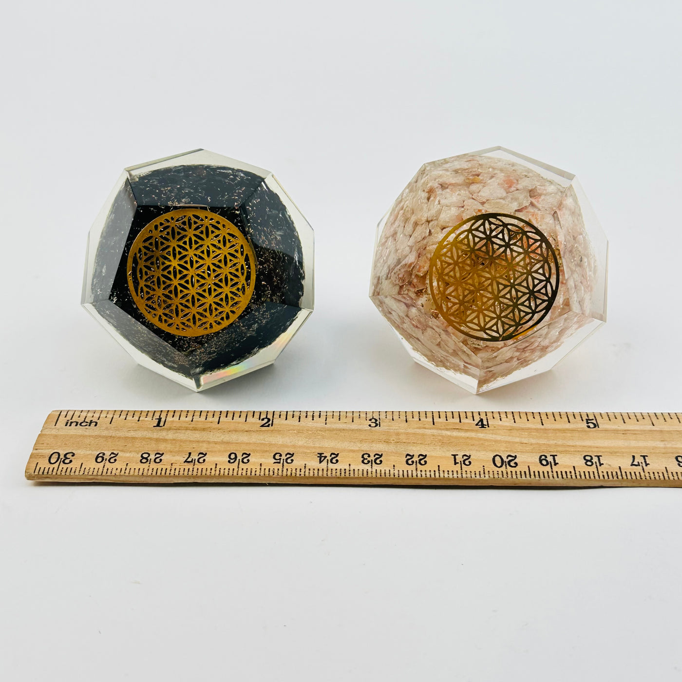 Crystal Orgone Dodecahedron with Flower of Life next to a ruler for size reference 