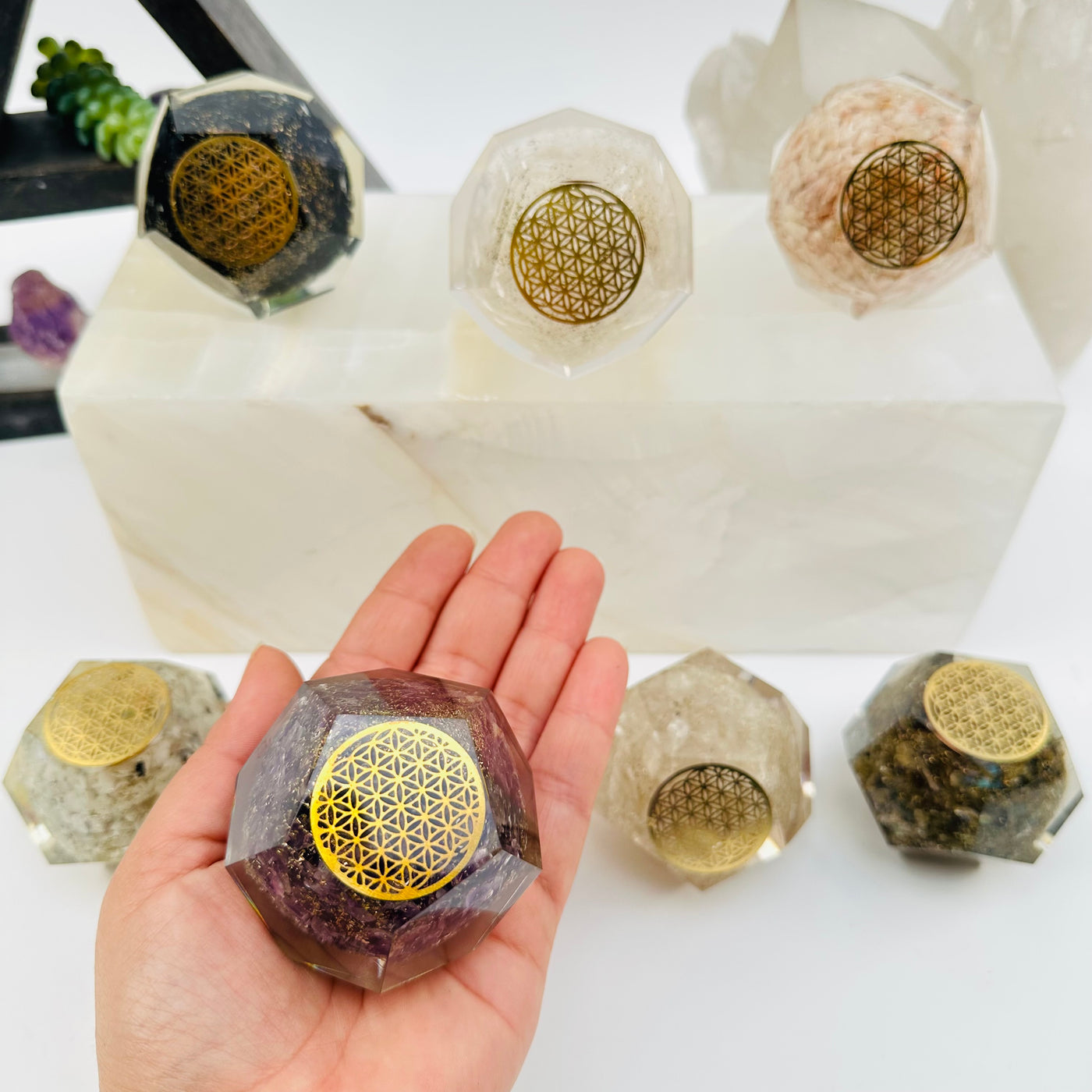 Crystal Orgone Dodecahedron with Flower of Life on hand for size reference 