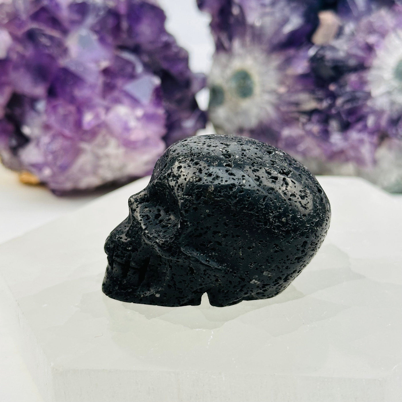 skull head carved out of lava stone 