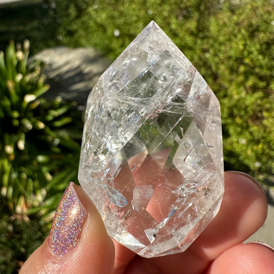 close up of the details on this faceted crystal quartz egg point