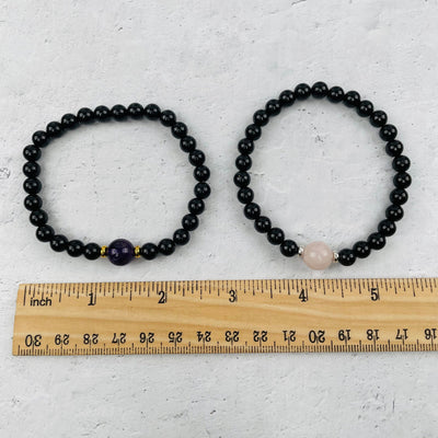 bracelet next to a ruler for size reference 