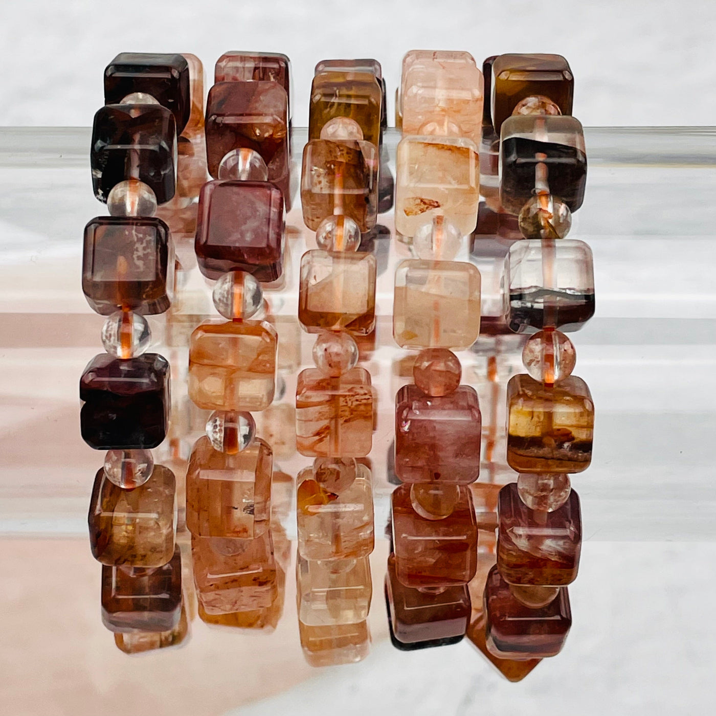 multiple Hematoid Quartz Cube Bead Bracelets displayed to show the differences in the patterns 
