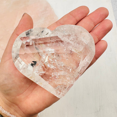 large crystal faceted heart in hand for size reference 