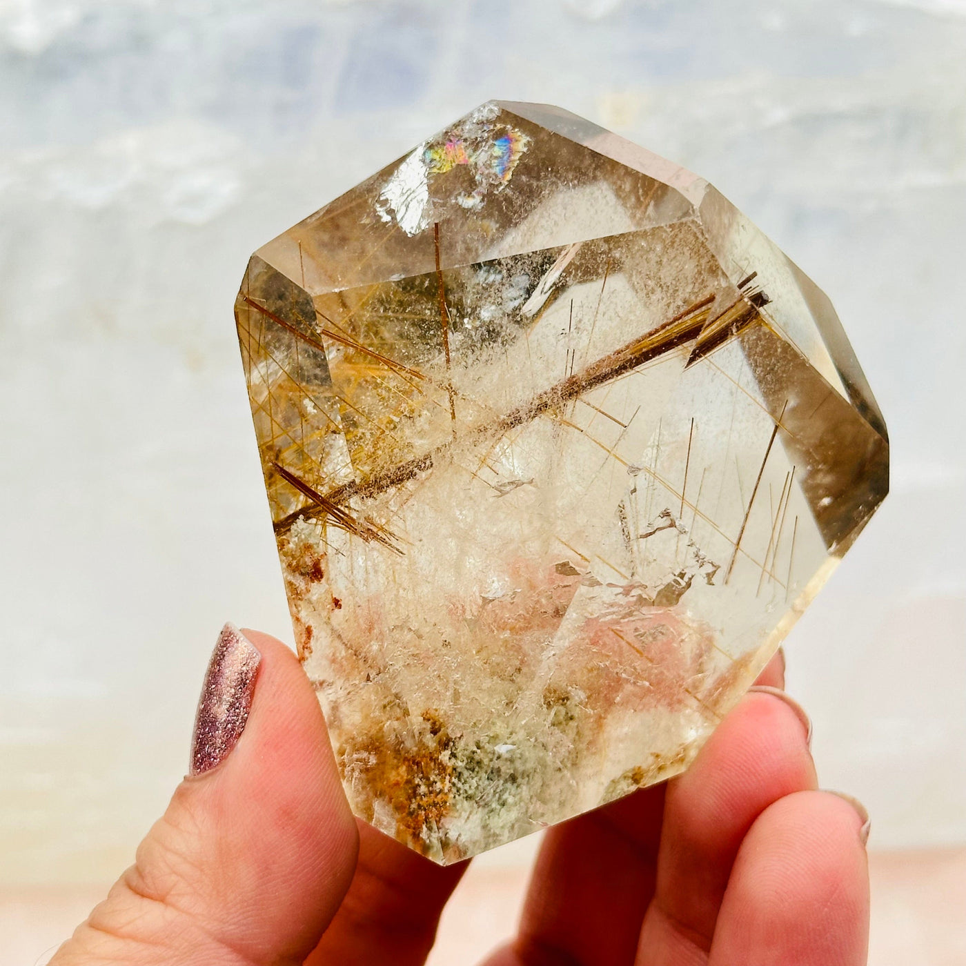 Rutilated Crystal Quartz in hand for size reference 
