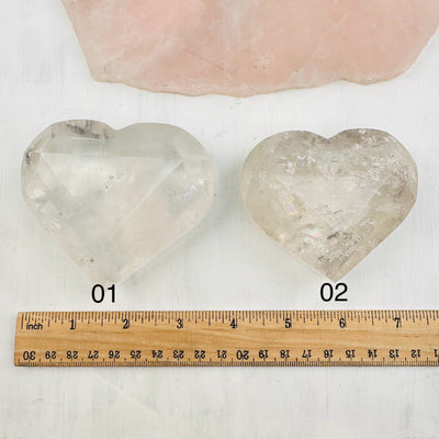 faceted smokey quartz hearts next to a ruler for size reference. you choose your favorite one