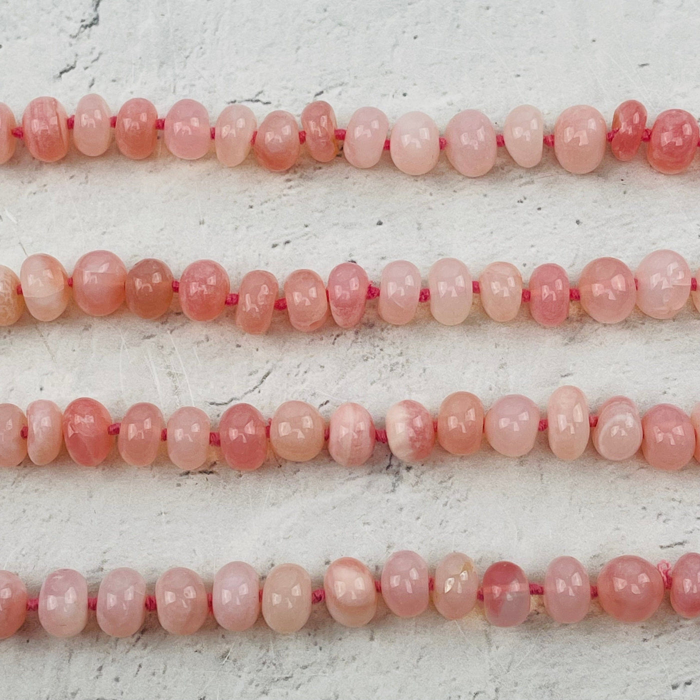 close up of the polished pink opal beads 