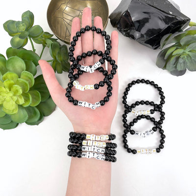 Black Obsidian Crystal Mala Bead Bracelet - WITCH  Letter Beads on a wrist and in hand