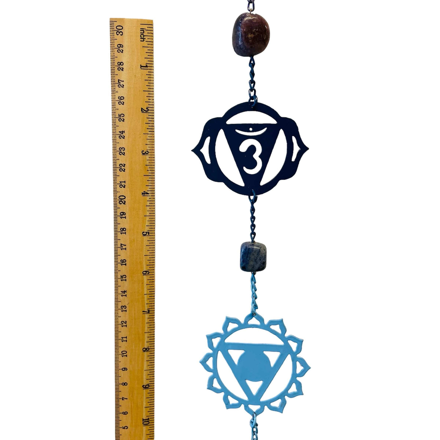 chakra symbols next to a ruler for size reference 