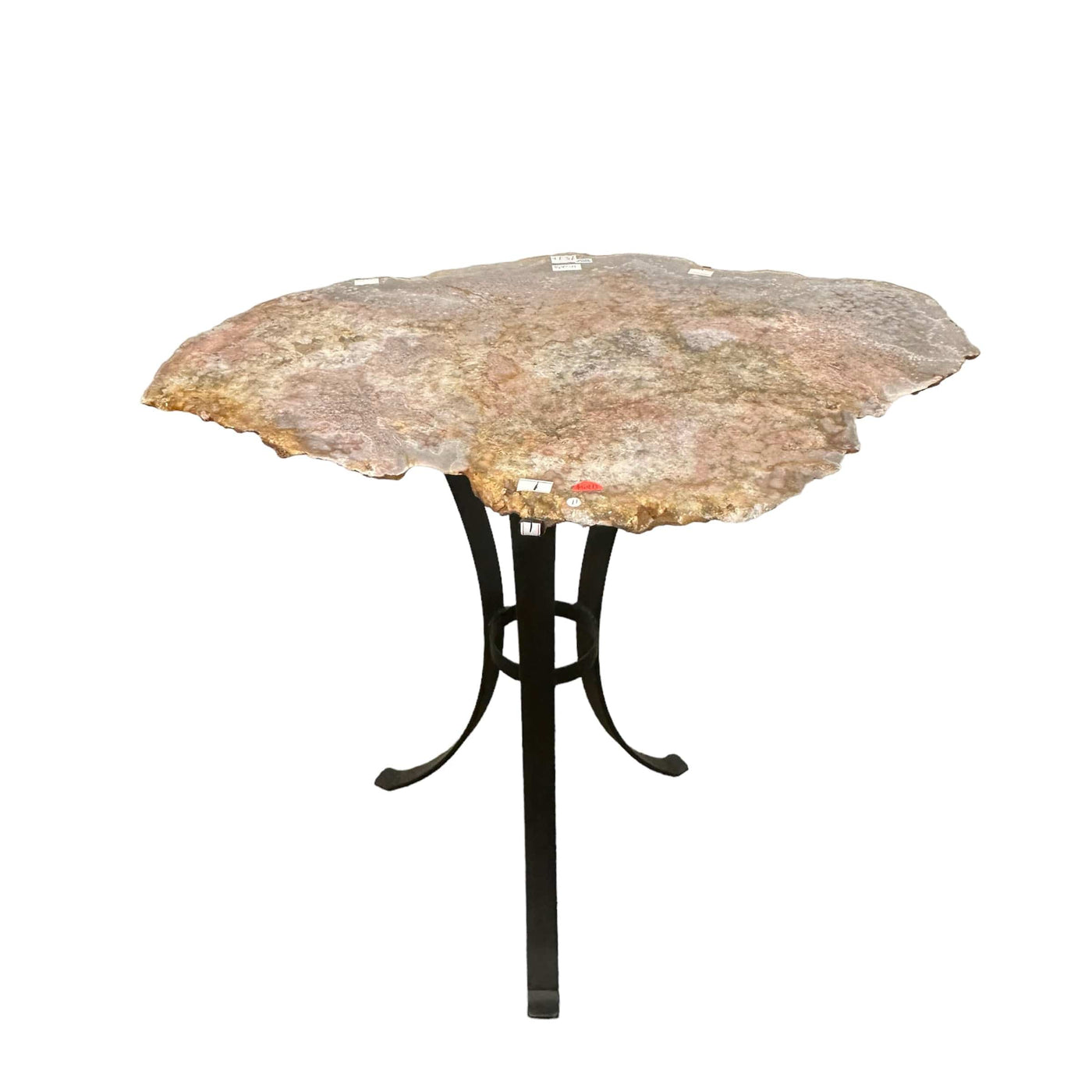 table is made out of a slab of pink amethyst that has been polished smooth on top