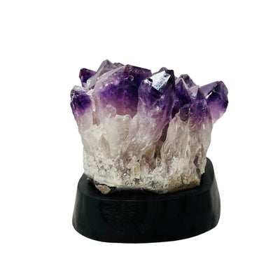 crystal cluster comes on a wooden base 