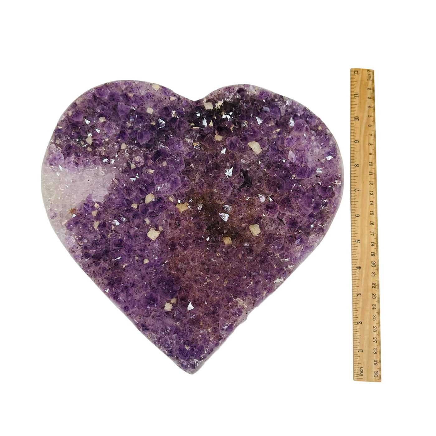 amethyst heart next to a ruler for size reference 