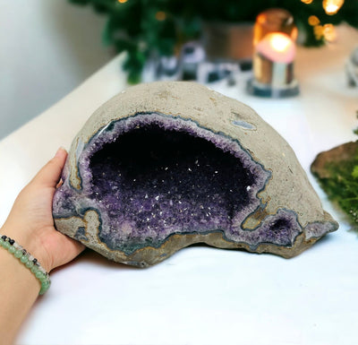 Amethyst Geode - Natural Crystal Geode  next to hand for size reference 
