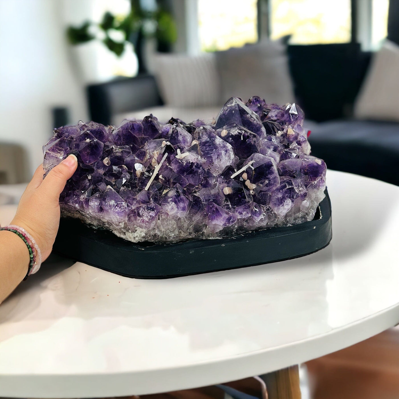 Amethyst Crystal Cluster on Wooden Base - Large Table Setting next to hand for size reference 