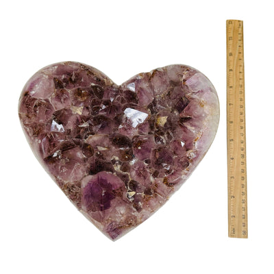 amethyst heart next to a ruler for size reference 