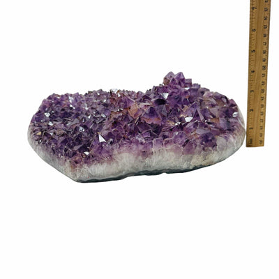 amethyst heart next to a ruler to show the thickness 