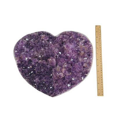 large amethyst hearts next to a ruler for size reference 