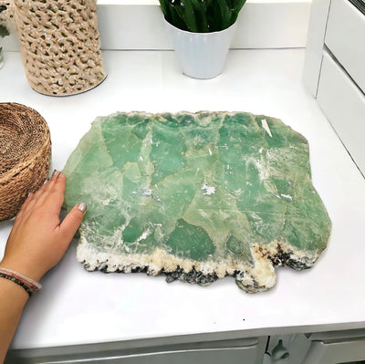 Large Fluorite Platter next to hand for size reference 
