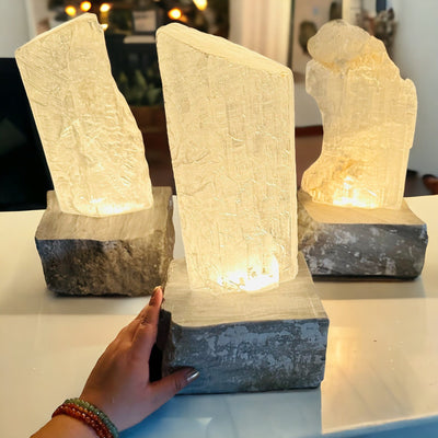 Selenite Lamp with Gray Onyx base next to hand for size reference 