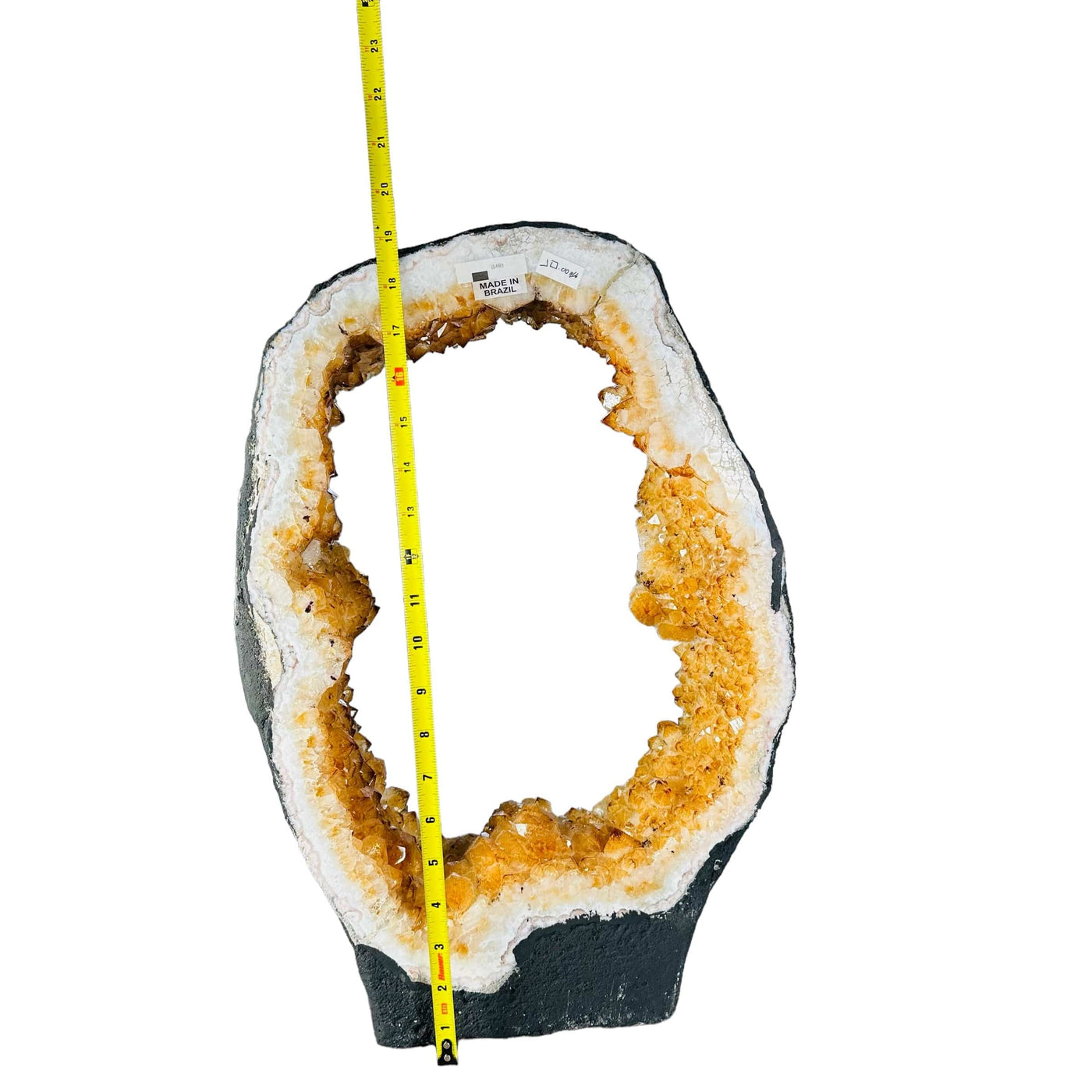 Citrine Crystal Portal cut base next to a ruler for size reference 