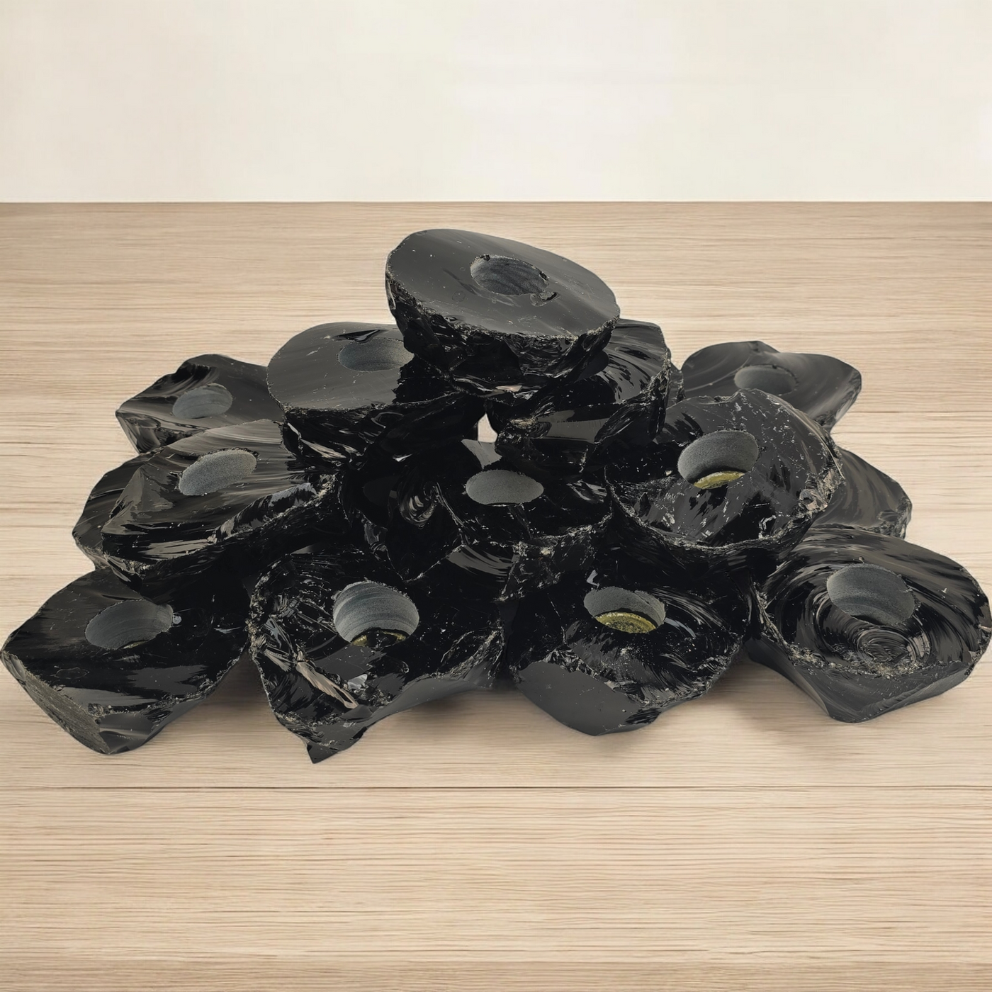 Black Obsidian Candle Holder - Pack of 20 Crystal Candle Holders - Wholesale Bulk Deal side view stacked on wooden surface