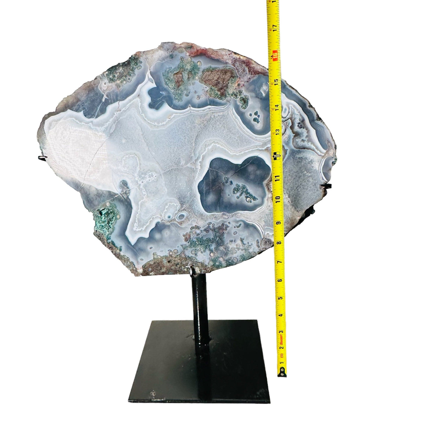 agate on stand next to a ruler for size reference 