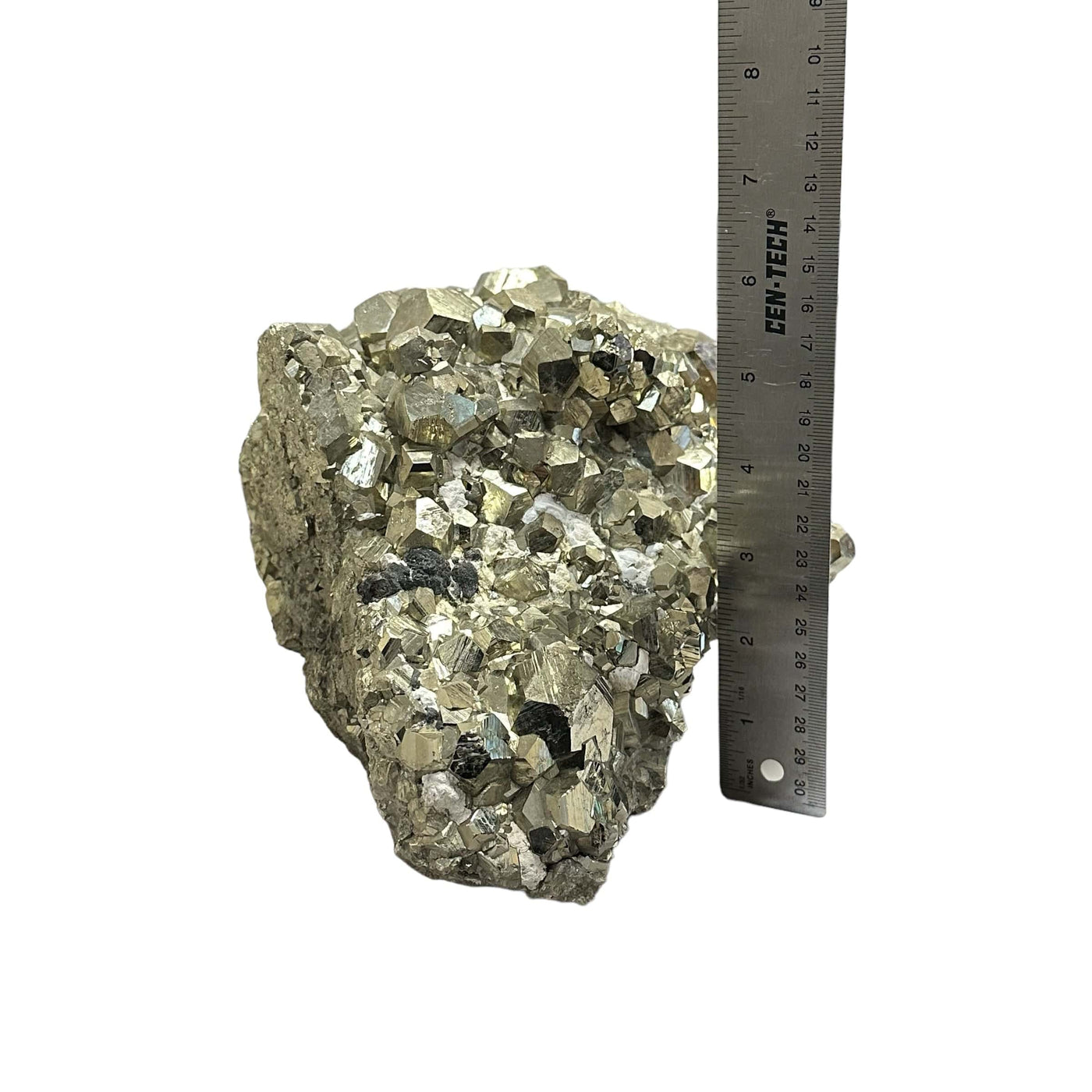 Large Pyrite cluster with Hexagon formations next to a ruler for size reference 