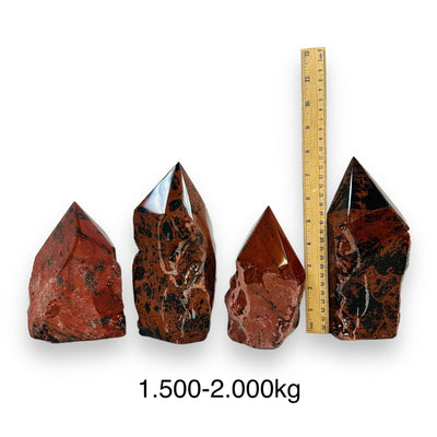 Mahogany Obsidian Crystal Semi Polished Cut Base - By weight - next to a ruler for size reference