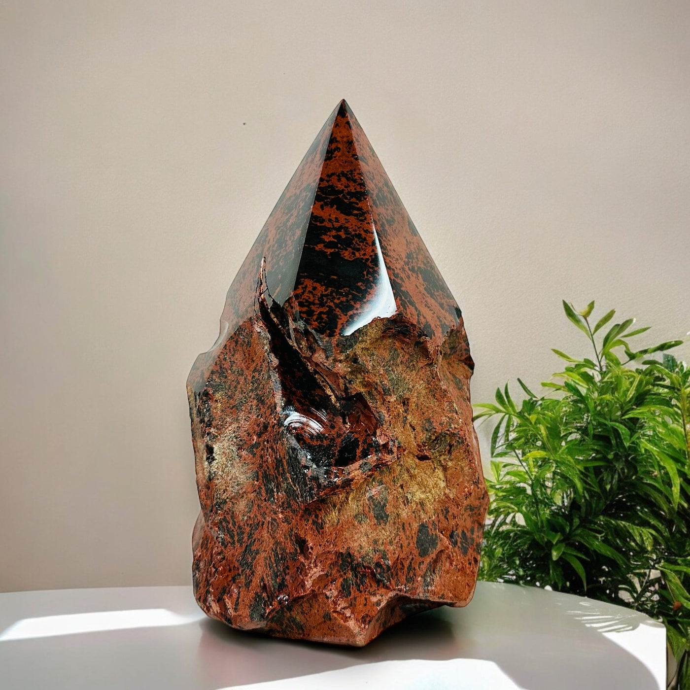 Mahogany Obsidian Crystal Semi Polished Cut Base displayed as home decor