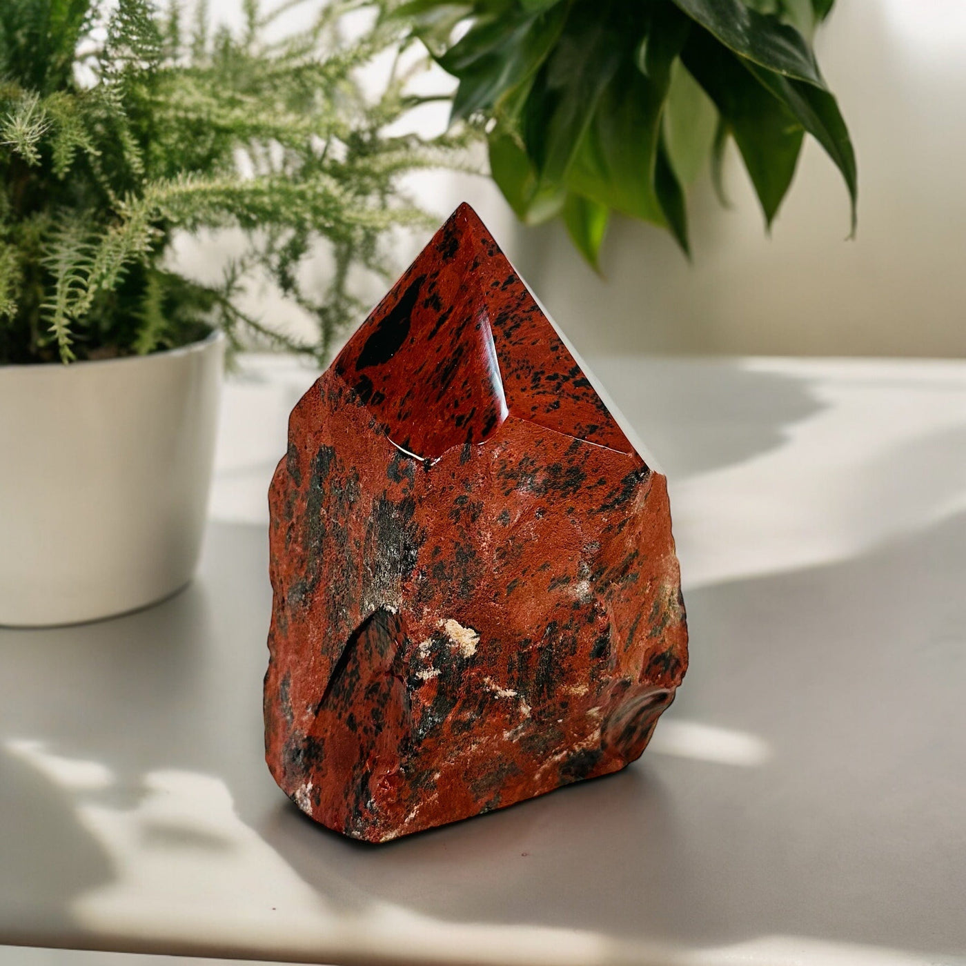 Mahogany Obsidian Crystal Semi Polished Cut Base displayed as home decor