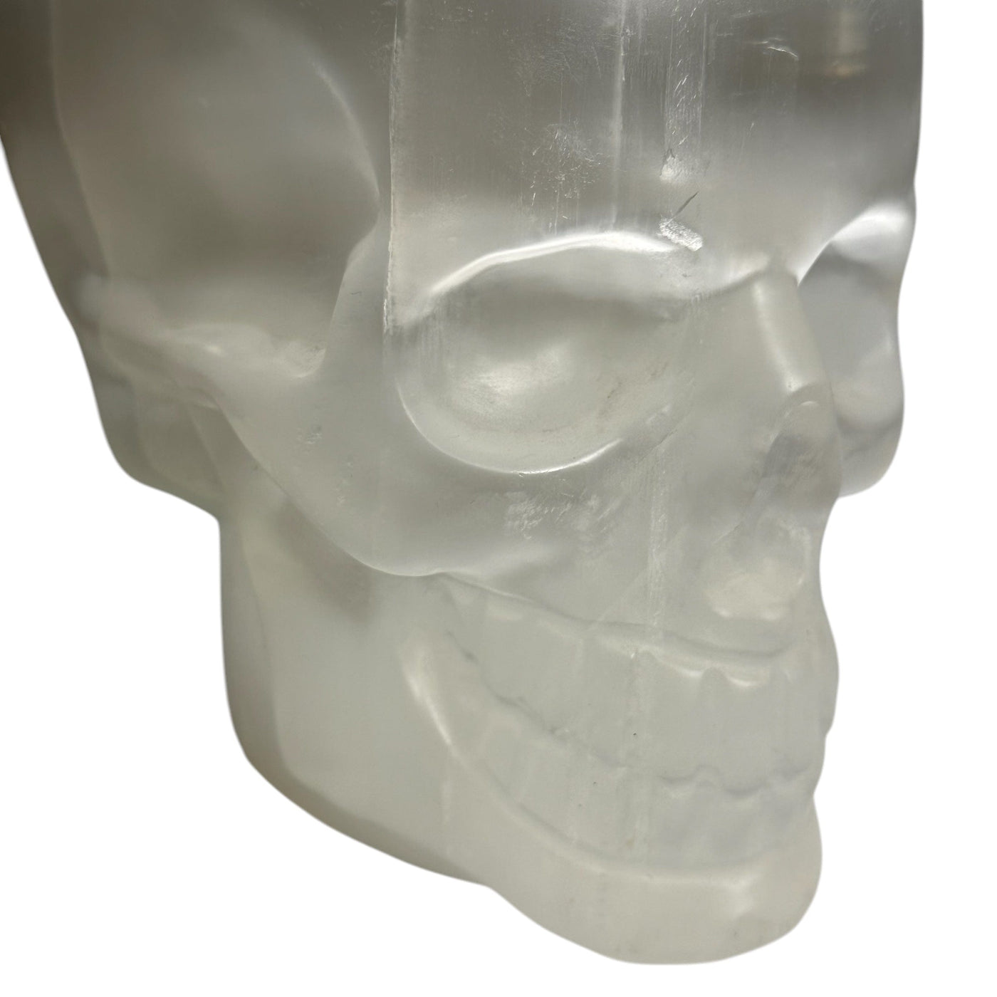 close up of the engraved details on this selenite skull 