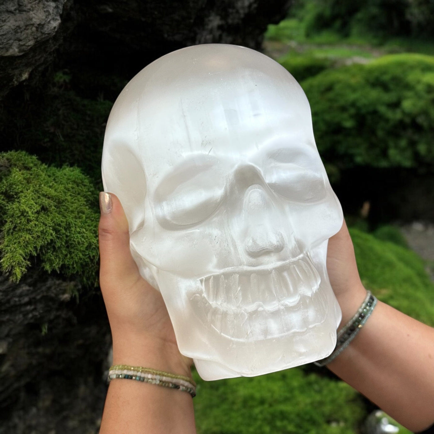 large selenite crystal skull in hands for size reference   