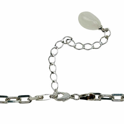 close up of the details on the necklace clasp. it has a small crystal charm on the end 