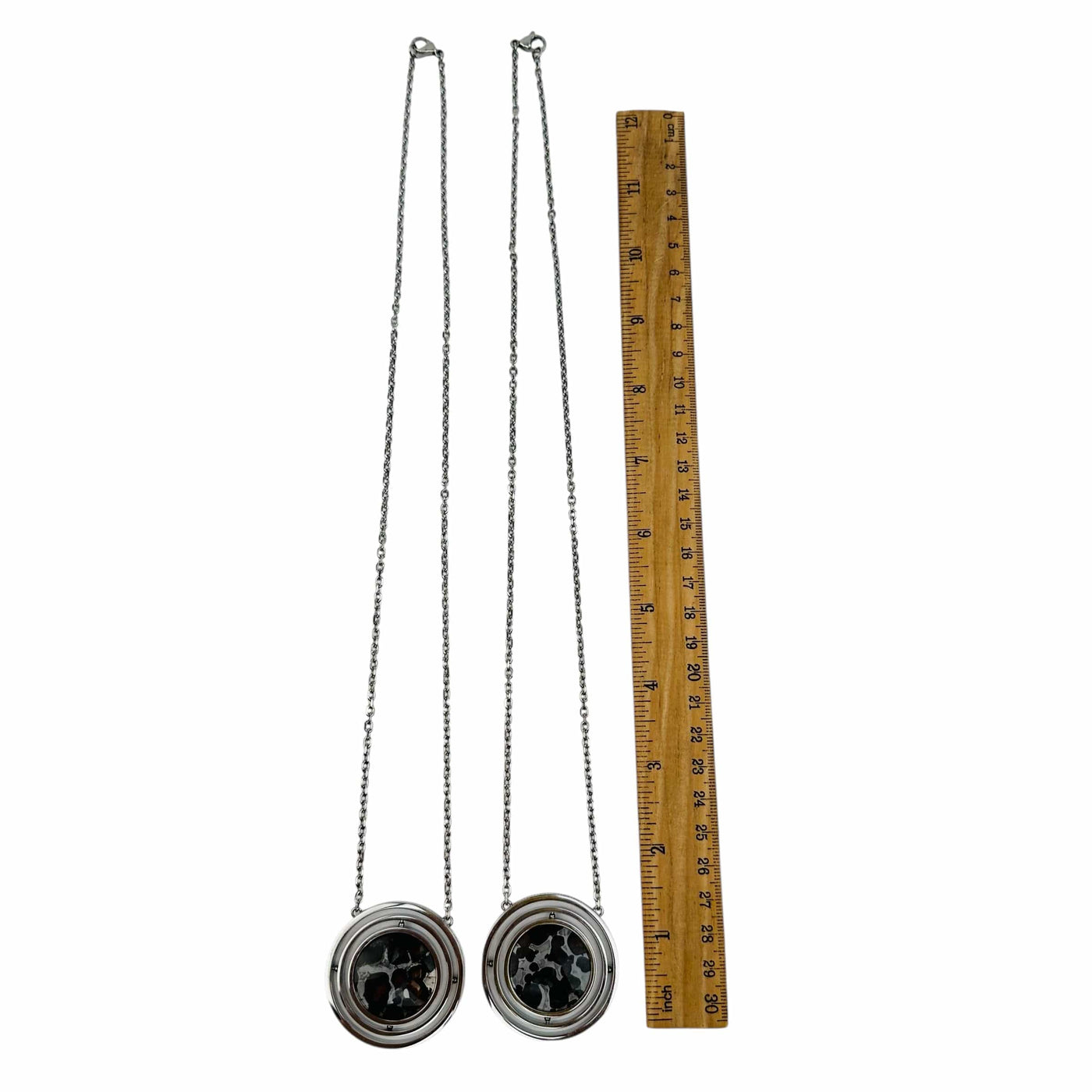 necklaces next to a ruler for size reference 