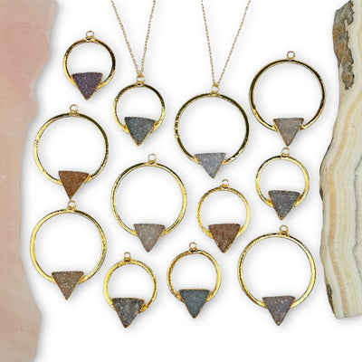 multiple druzy triangle hoop pendants displayed to show the differences in the sizes and color shades 
