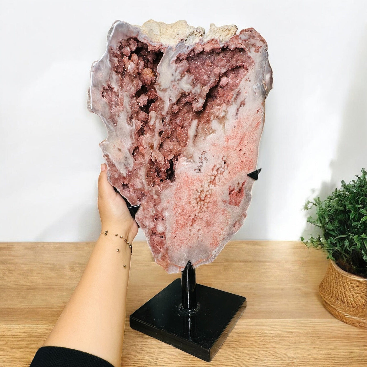 pink amethyst crystal on metal stand displayed as home decor 