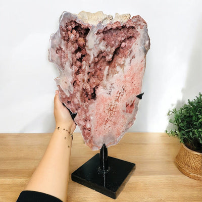 pink amethyst crystal on metal stand displayed as home decor 