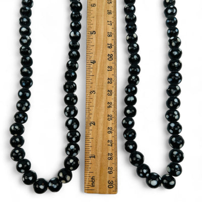 close up of the beads displayed next to a ruler for size reference 
