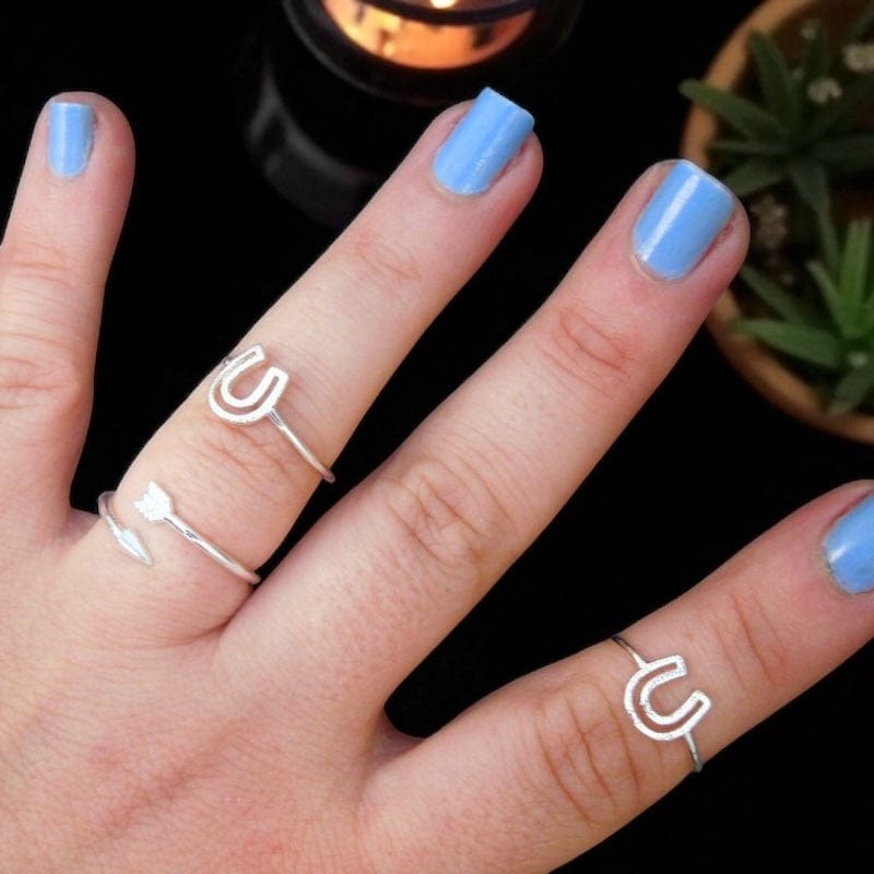 Textured Midi Horseshoe Rings displayed on hand for size reference 