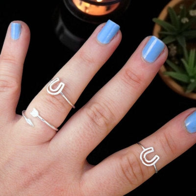 Textured Midi Horseshoe Rings displayed on hand for size reference 